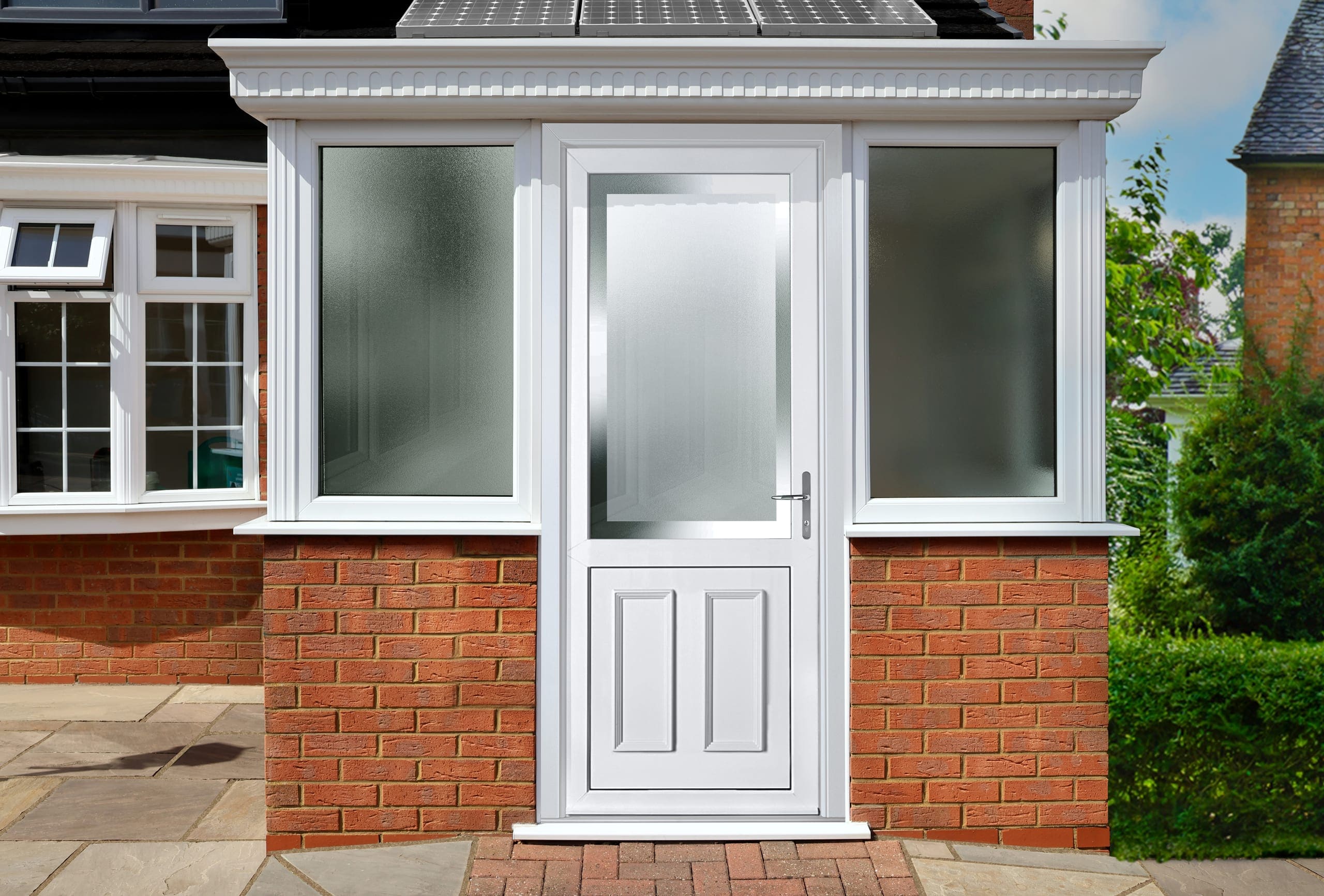 White uPVC front door under a porch canopy on a brick house